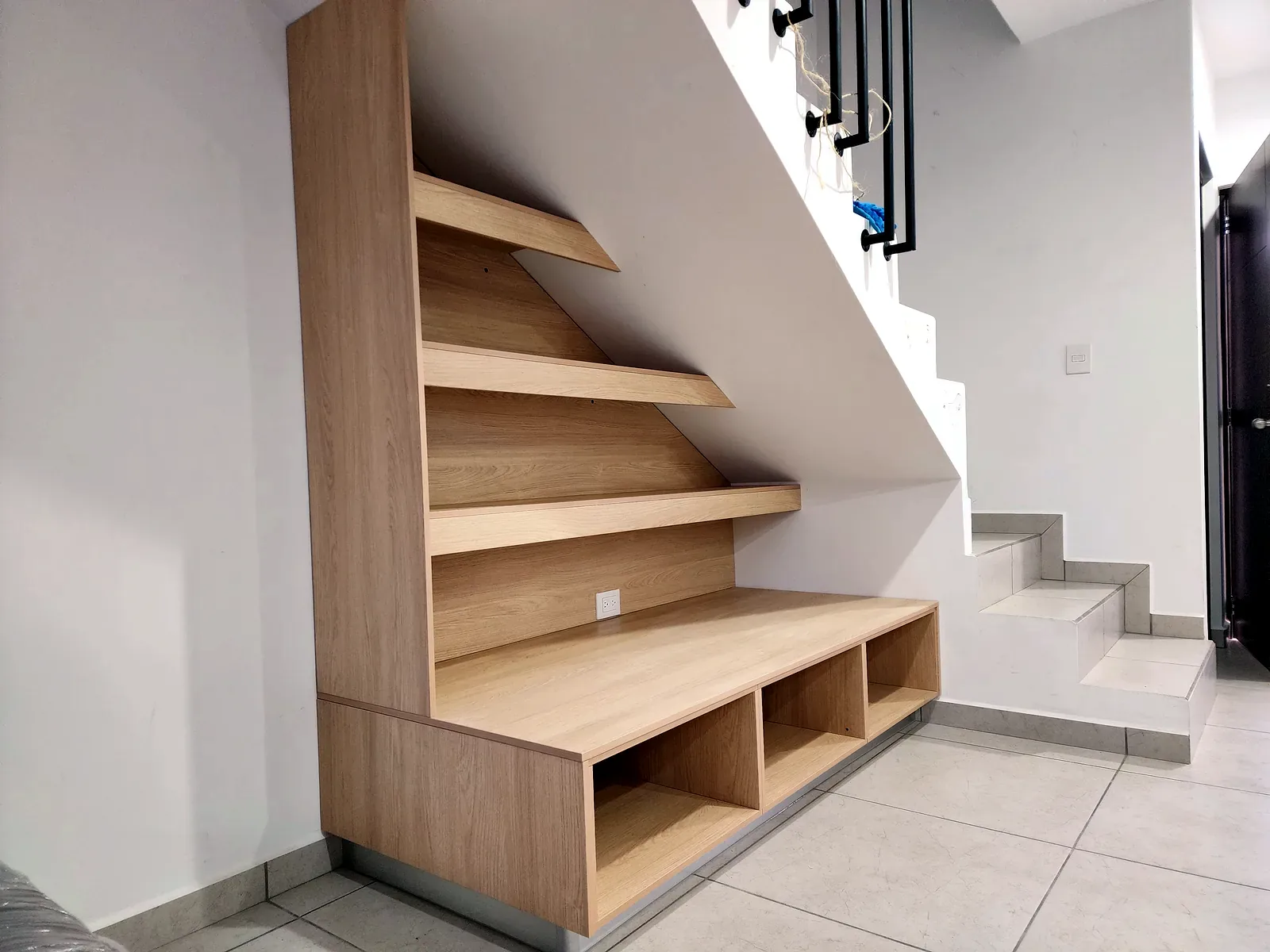 Mueble bajo escalera a medida con repisas y módulos inferiores en Culiacán